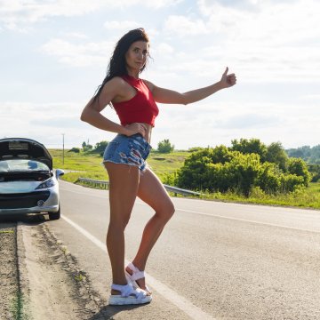 warranty direct extended car warranty review overview car on the side of the road open hood woman hitchhiking